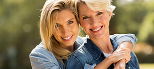 Two women with healthy smiles after periodontal therapy