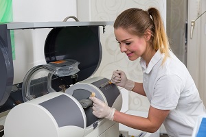 Dental assistant using CEREC milling unit