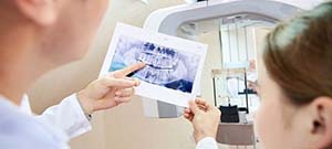 Emergency dentist in Lenox Hill showing X-ray to patient