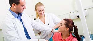 Dentist explaining cost of emergency dentistry in Lenox Hill