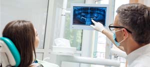 dentist showing a patient their dental X-rays 