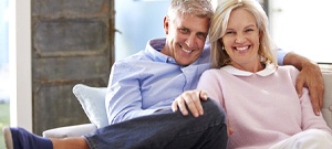 elderly couple sitting on couch