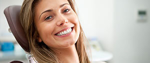 Smiling woman in dental chair for preventive dentistry