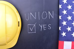 Hard hat and flag on chalk board that says Union