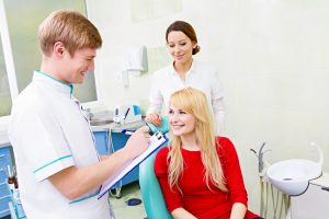 Female patient discussing cosmetic dentistry services with dentist