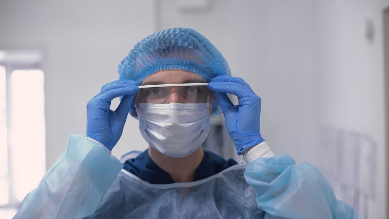 Dentist wearing personal protective equipment