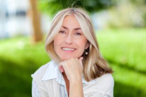 Older woman with dental implants smiling